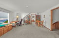 Unwind in your peaceful retreat featuring ocean views, a cozy reading nook, and workspace with warm wood furnishings.