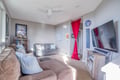 Settle into your cozy living room with plush seating, entertainment center, and thoughtful nautical touches that make this space perfect for relaxing.