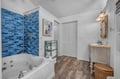 Unwind in your spa-like bathroom with stunning blue mosaic tiles, jetted tub, and coastal charm throughout.