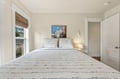 Drift off in this bright, airy bedroom with soft natural light and calming coastal tones. Your restful retreat awaits with crisp linens and a peaceful ambiance.