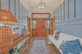 Step through the welcoming entrance into a bright, coastal-inspired space with charming wicker touches and elegant tiled floors—your seaside escape begins here.