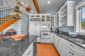 Your gourmet kitchen awaits with gleaming granite counters, stainless appliances, and copper pots ready for culinary adventures.
