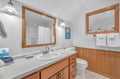 Refresh in your well-appointed bathroom featuring warm wood accents, granite counters, and a relaxing tub perfect for unwinding after mountain adventures.