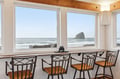 Enjoy morning coffee at this scenic dining nook, where panoramic ocean views and the iconic sea stack create your perfect coastal breakfast spot.