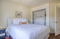Your serene retreat awaits with crisp white linens, charming tiger accents, and a spacious built-in for your belongings. Sink into comfort and unwind.