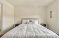 Sink into a plush bed dressed in soft linens, with cozy nightstands at your side. Natural light filters through, creating a peaceful retreat where restful sleep comes easy.