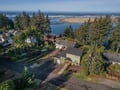 Aerial view showcasing the property's prime coastal location, with pristine beaches and ocean waters just moments from the front door.