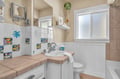 Your charming bathroom features colorful sea-themed tiles, creating a playful coastal vibe perfect for relaxing after beach adventures.