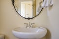 Step into your private sanctuary with a gleaming sink, elegant mirror, and plush towels ready for your comfort.