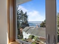 Wake up to stunning ocean views through your window, with waves and evergreen forests creating the perfect coastal retreat backdrop.