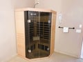 Unwind in your private corner sauna with cedar walls and gentle heat therapy for ultimate relaxation.