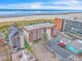 Coastal property location with direct beach access and stunning oceanfront positioning in a vibrant seaside community.