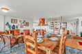 Gather around the rustic wooden dining table where your family meals become cherished memories, surrounded by nautical charm and open kitchen convenience.