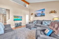 Sink into plush gray sectionals while enjoying your favorite shows on the large TV in this bright, coastal-themed living space.