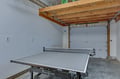 Challenge friends to exciting table tennis matches in your private garage game room with professional equipment.
