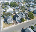 Aerial view of the property nestled in a charming residential neighborhood, showing the home's distinctive architecture and peaceful surroundings near the waterfront.