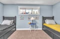 Your kids will love this nautical-themed room with twin beds and playful coastal decor creating the perfect seaside adventure.