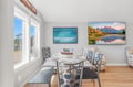 Picture yourself sharing meals with loved ones at this elegant dining table, bathed in natural light from expansive windows. The peaceful mountain artwork and coastal-inspired décor create a serene, welcoming atmosphere for your mountain getaway.