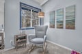 Sink into your cozy reading chair by the window, where soft light and tranquil artwork create the perfect spot for morning coffee or evening relaxation.