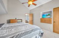 Your peaceful bedroom features a comfortable bed, wall-mounted TV, and ceiling fan to keep you cool during restful nights.