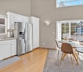Enjoy morning coffee in this bright kitchen and dining space flooded with natural light. The open layout invites you to cook, dine, and unwind while taking in the peaceful surroundings just beyond the glass doors.