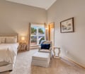 Sink into the plush armchair by your window and let the natural light warm your peaceful retreat after a day of coastal adventures.
