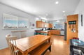 Step into a bright, airy kitchen with warm wood cabinetry and a welcoming dining table where your group can gather for meals and easy conversation.