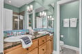 Unwind in your spa-like bathroom with soothing mint walls, granite counters, and whimsical ocean tile backsplash that brings coastal charm to your daily routine.