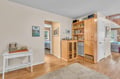 Relax in this bright living space with charming wood built-ins, perfect for storing your belongings and displaying treasured books and games.