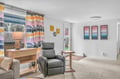 Relax in your bright living space with colorful artwork and comfortable seating, perfect for unwinding after exploring.