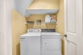 Your dedicated laundry nook keeps your vacation wardrobe fresh with a full-size washer, dryer, and organized storage for towels and supplies.