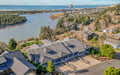 Aerial view showcases this coastal property nestled between river and ocean, with Haystack Rock visible offshore and Pacific City's charming community surrounding the area.