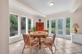 Gather around this sunny dining space where garden views surround your meals and French doors invite morning coffee on the patio.