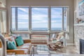 Relax in your bright living space with stunning sea views and cozy seating perfect for unwinding after exploring.