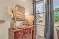Stylish bedroom dresser with vintage charm and nautical touches—your perfect spot to unpack and settle into your vacation retreat.