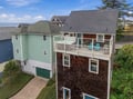 This charming coastal property features a spacious balcony with sweeping ocean views, surrounded by a peaceful neighborhood. The upper-level deck overlooks tranquil waters, offering an ideal setting for morning coffee or evening relaxation.