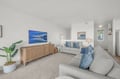 Unwind in this bright, coastal-inspired living room where plush sofas invite you to relax after a day of exploring. Ocean-themed artwork and soft blue accents create a tranquil, beach-house vibe perfect for unwinding.