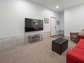 Unwind in your spacious living room with plush seating, large flat-screen TV, and modern comfort for relaxing evenings.