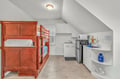 Your cozy attic retreat combines comfort and convenience with warm wood bunk beds and a fully equipped kitchenette for memorable stays.