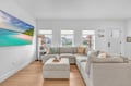 Sink into plush sectional seating while tropical artwork transports you to paradise in this bright, airy living space.