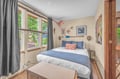 Sink into crisp linens after a day of adventures. Your bedroom blends nautical charm with beachy warmth, welcoming natural light and garden views to start your mornings right.