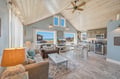 Relax in this bright open-concept space with vaulted wood ceilings and ocean views. Your retreat features a fully equipped kitchen, comfortable seating, and coastal charm—a perfect home base for your beach getaway.