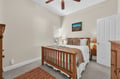 Drift off to sleep in your cozy bedroom, complete with a ceiling fan, crisp linens, and warm wood furnishings.