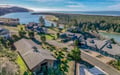 Coastal vacation rental community featuring residential homes with bay and river access, surrounded by lush evergreen forests near the Pacific Ocean.