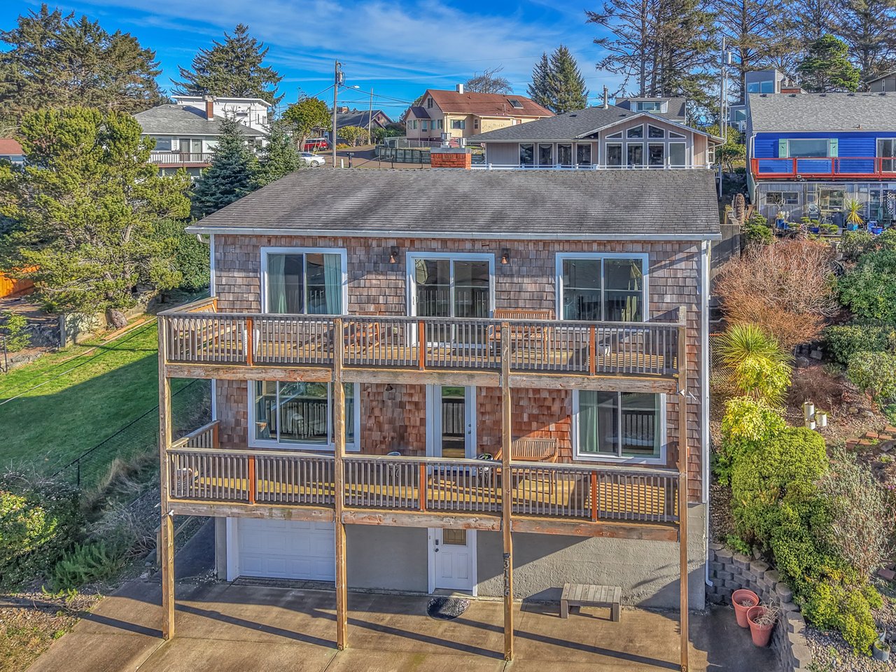 Charming coastal property featuring multi-level balconies and shingled exterior in a peaceful residential neighborhood.