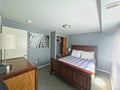 Sink into this cozy bedroom with rich wood furnishings and soft linens, where restful nights await after your adventures.