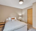Unwind in your serene bedroom, featuring a plush bed, warm lighting, and thoughtful touches that invite you to relax and recharge.