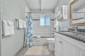 Your bright bathroom features coastal charm with soft mint walls, granite counters, and fresh towels ready for your stay.
