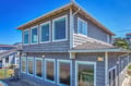 Charming coastal retreat with weathered shingle siding and abundant windows framing the beautiful seaside setting.