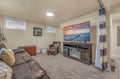 Cozy up in your private lower-level retreat with plush seating, glowing fireplace, and big-screen entertainment for perfect evening relaxation.